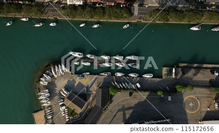 Italy, Peschiera del Garda, Lake Garda - Top view of the port of Lake Como. Yacht Club. Moored yachts and motorized private boats. The pier is made of wood. Beautiful clear water. Italy, Peschiera del Garda, Lake Garda - Top view of the port of Lake Como. Yacht Club. Moored yachts and motorized private boats. The pier is made of wood. Beautiful clear water. 115172656
