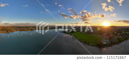 Panoramic view of boats on the Tamaki river at sunset in Auckland, NZ Panoramic view of boats on the Tamaki river at sunset in Auckland, NZ 115172867