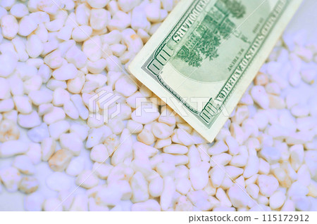 Paper currency. one hundred dollars banknote on light stones Paper currency. one hundred dollars banknote on light stones 115172912