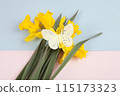 a bouquet of daffodils with a butterfly on it 115173323