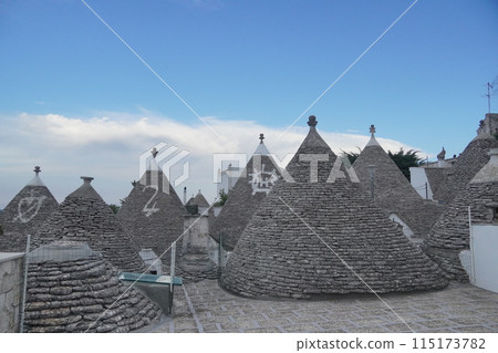 Alberobello roofs and blue sky Alberobello roofs and blue sky 115173782