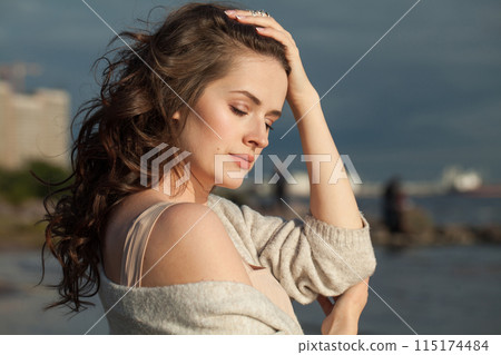 Attractive young lady brunette model on sea beach. Beauty woman with makeup 115174484