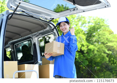 Delivery driver woman carrying luggage outside Delivery driver woman carrying luggage outside 115176673