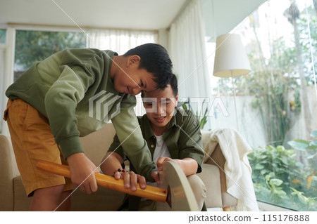 Father and Son Assembling Furniture 115176888