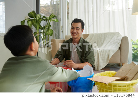 Father and Son Learning about Recycling 115176944