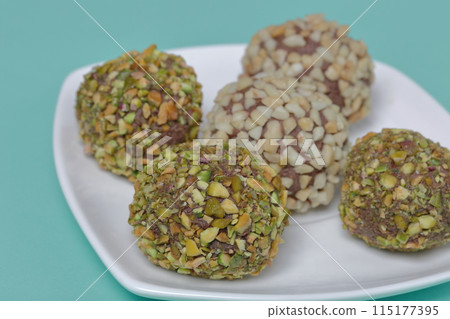 Homemade sweets. Chocolate truffles with a crumb of peanuts and pistachios. Homemade sweets. Chocolate truffles with a crumb of peanuts and pistachios. 115177395