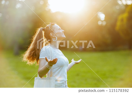 happy modern 40 years old woman in white shirt enjoying happy modern 40 years old woman in white shirt enjoying 115178392