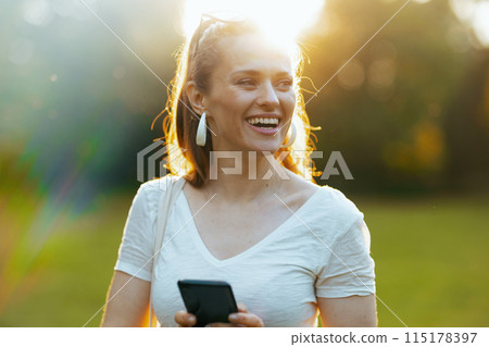 smiling modern 40 years old woman in white shirt smiling modern 40 years old woman in white shirt 115178397