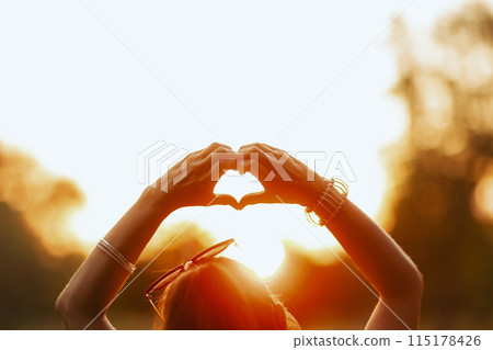 happy 40 years old woman in shirt showing heart hands happy 40 years old woman in shirt showing heart hands 115178426