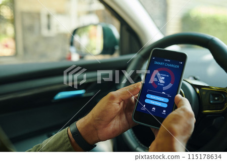 Driver Checking Charging Level 115178634