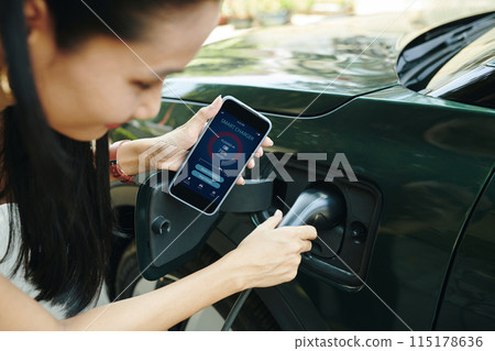 EV Owner Using Smart Charger App 115178636