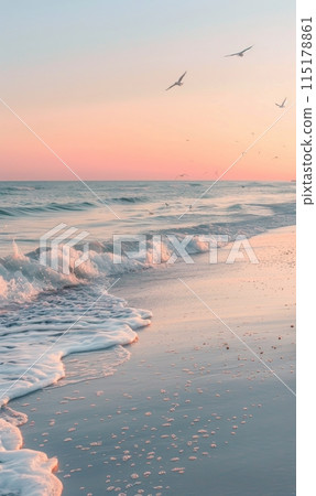 Pink Sunset Over Gentle Ocean Waves on Sandy Beach 115178861