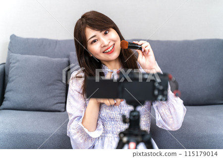 Woman taking a video Woman taking a video 115179014