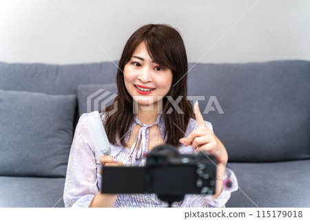 Woman taking a video Woman taking a video 115179018