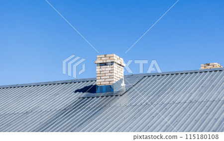 White chimney made of bricks is on a rural house roof u 115180108