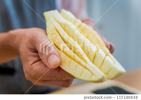 Chef at the kitchen preparing grilled eggplants with garlic 115180838