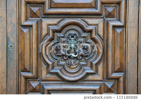 TURIN, ITALY - SEP 14, 2019: Beautiful handmade heavy wooden door, the famous Devil's Door, in the old town of Turin 115180886