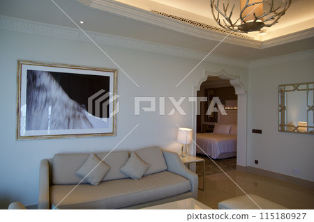 RAS AL KHAIMAH, UNITED ARAB EMIRATES - JUN 11, 2019: Luxurious hotel room with cream colored sofa in a five star hotel 115180927