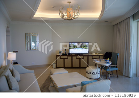 RAS AL KHAIMAH, UNITED ARAB EMIRATES - JUN 11, 2019: Luxurious hotel room with cream colored sofa in a five star hotel RAS AL KHAIMAH, UNITED ARAB EMIRATES - JUN 11, 2019: Luxurious hotel room with cream colored sofa in a five star hotel 115180929