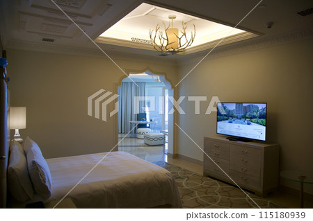 RAS AL KHAIMAH, UNITED ARAB EMIRATES - JUN 11, 2019: King-size bed in a luxurious hotel room in a five star hotel 115180939