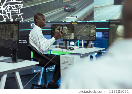African american call center operator tracking orders for clients, helping couriers find routes in city traffic for express shipping. Monitoring trucks and update clients on potential delay. 115181021