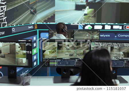 African american employee following delivery trucks around the city, sending gps coordinates for cargo location by using satellite map. Monitoring couriers in traffic on CCTV footage. 115181037