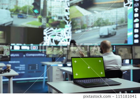 Diverse employees monitoring delivery trucks routes with an isolated screen laptop, following alternative routes on satellite map and radar. Diverse people work on order tracking. Diverse employees monitoring delivery trucks routes with an isolated screen laptop, following alternative routes on satellite map and radar. Diverse people work on order tracking. 115181041