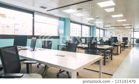 Interior of bright creative coworking workspace with computer desks 115181470