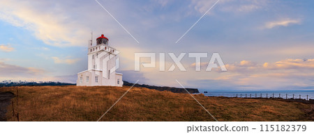 Picturesque autumn evening view to Dyrholaey lighthouse and Reynisfjara ocean black volcanic sand beach in far, Vik, South Iceland. People unrecognizable. 115182379