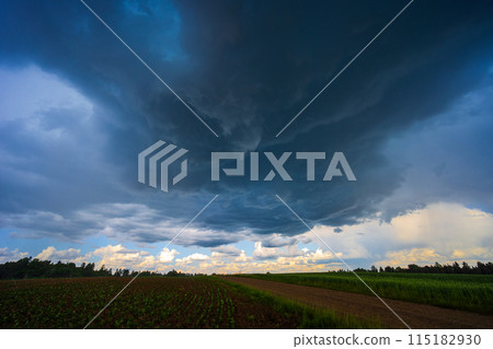 Dramatic storm clouds in blue sky associated with storm, dark, moody weather and looming atmosphere Dramatic storm clouds in blue sky associated with storm, dark, moody weather and looming atmosphere 115182930