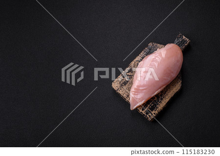 Fresh chicken fillet on a dark concrete table with spices and herbs 115183230