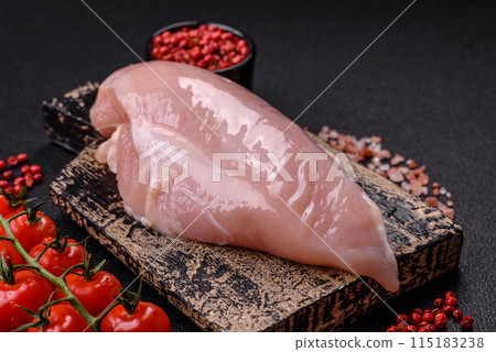 Fresh chicken fillet on a dark concrete table with spices and herbs 115183238