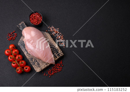 Fresh chicken fillet on a dark concrete table with spices and herbs Fresh chicken fillet on a dark concrete table with spices and herbs 115183252