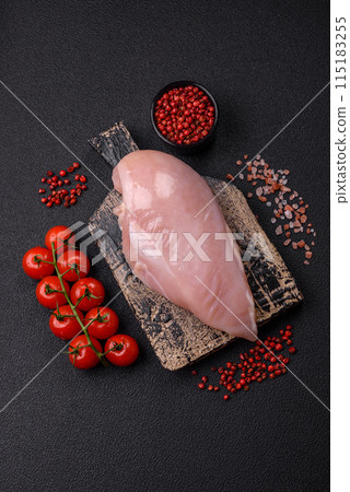 Fresh chicken fillet on a dark concrete table with spices and herbs 115183255