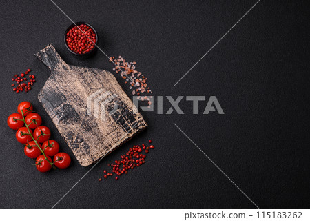 Black background with copy space with cherry tomatoes, salt, spices 115183262