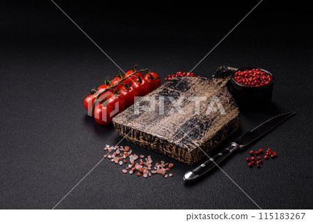 Black background with copy space with cherry tomatoes, salt, spices Black background with copy space with cherry tomatoes, salt, spices 115183267