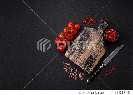 Black background with copy space with cherry tomatoes, salt, spices Black background with copy space with cherry tomatoes, salt, spices 115183268