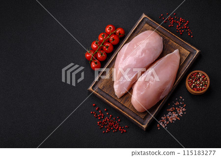 Fresh chicken fillet on a dark concrete table with spices and herbs 115183277
