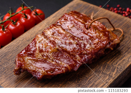 Delicious juicy grilled ribs baked on the grill with salt, spices and herbs 115183293
