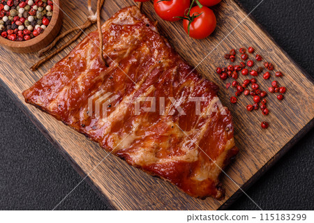 Delicious juicy grilled ribs baked on the grill with salt, spices and herbs 115183299