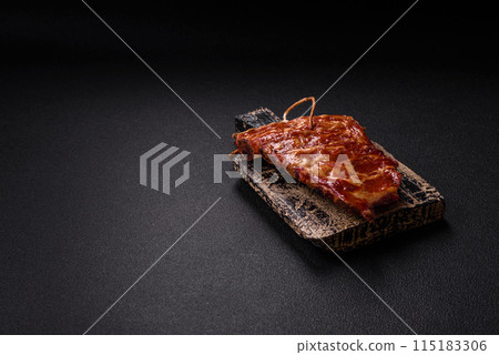 Delicious juicy grilled ribs baked on the grill with salt, spices and herbs 115183306