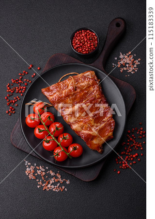 Delicious juicy grilled ribs baked on the grill with salt, spices and herbs Delicious juicy grilled ribs baked on the grill with salt, spices and herbs 115183339