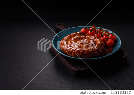 Delicious homemade sausage in the form of a spiral baked on the grill with salt, spices 115183357