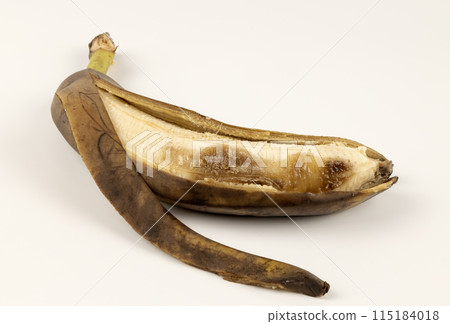 An overripe peeled banana. A rotten banana. 115184018