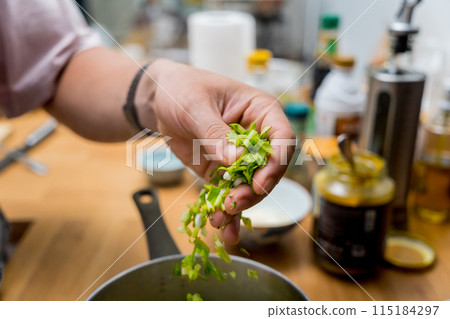 Chef at the kitchen preparing lentils soup with cauliflower and broccoli 115184297