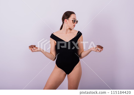 Close up young nice lady woman with slim body perfect skin nude top bra lingerie stand hold donut 115184420