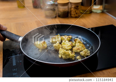 Chef at the kitchen preparing bean porridge with cauliflower and vegetables Chef at the kitchen preparing bean porridge with cauliflower and vegetables 115184941