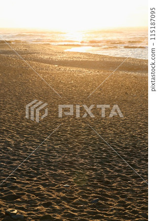 Footprints in the sand lit by the morning sun, Oarai Beach 115187095