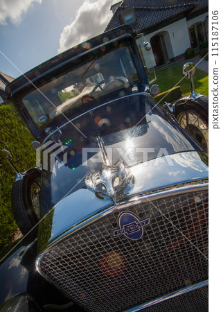 Vintage Antique Car Front View Shiny Classic Roadster on Driveway with Sunflare Reflection 115187106