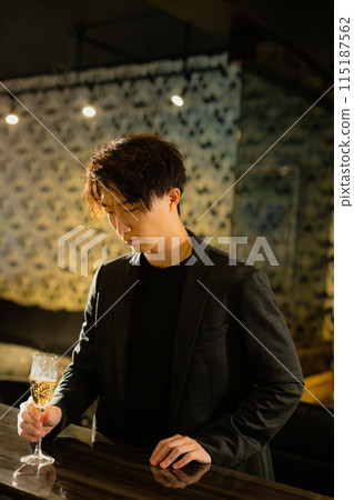 Man drinking at a bar 115187562
